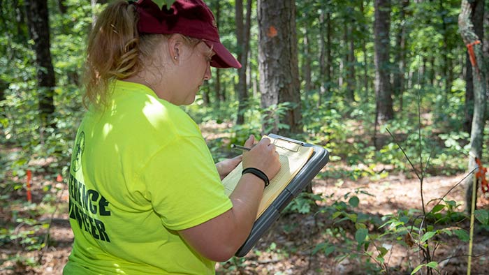 Student taking field notes for research