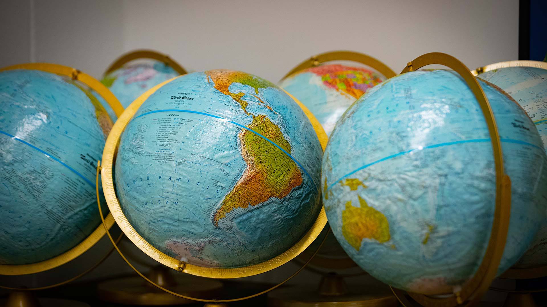 Several world globes next to eachother.