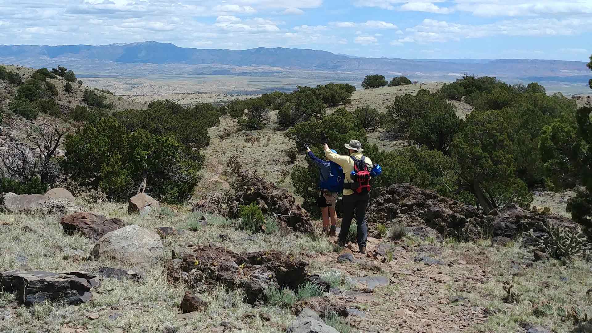 Members of Geology 413 field camp overlooking hilly terrain. 