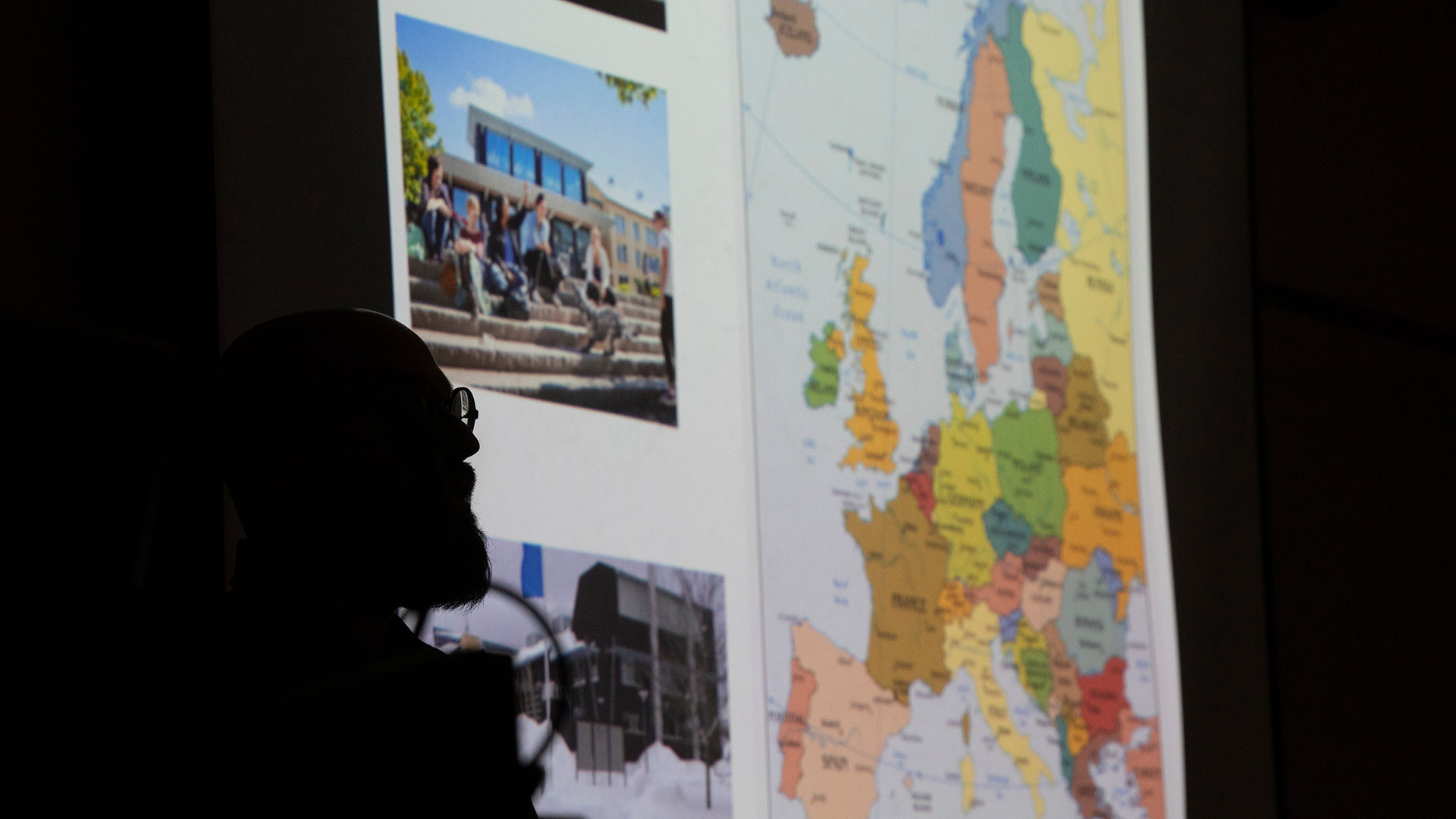 Silhouette of a person looking at a colorful map of Europe