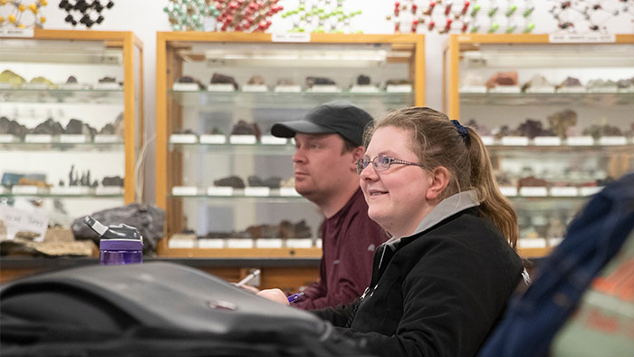 Two students listening in a classroom