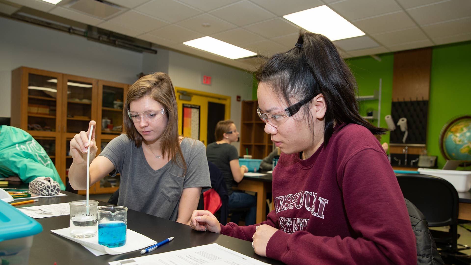 Two students completing a lab experiment