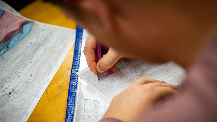 Student taking notes in a classroom