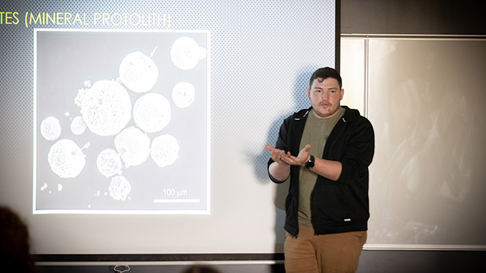 Person explaining an image on a screen in a classroom