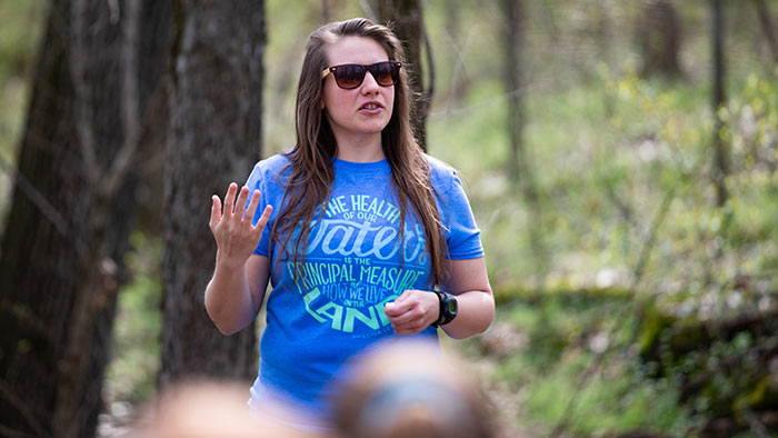 Person leading instruction in an outdoor setting.