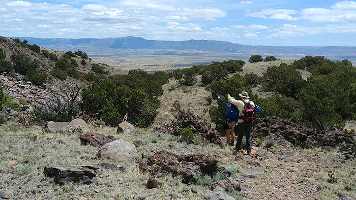 Field camp members overlooking valley